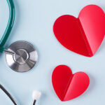 Stethoscope next to two hearts